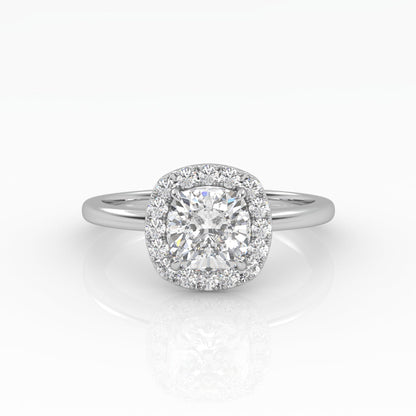 A gleaming cushion-cut diamond engagement ring set in elegant solitaire with halo style.